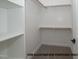 Spacious walk-in closet with shelves and wooden clothes rods for storage at 825 Willow Tower Ct, Rolesville, NC 27571