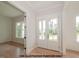 Inviting entryway featuring light hardwood floors, a double-door entry, and views into the adjacent room at 825 Willow Tower Ct, Rolesville, NC 27571