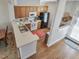 Functional kitchen with wooden cabinets, white appliances, and eat-in breakfast bar at 916 Highgrove Dr, Chapel Hill, NC 27516