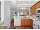 Kitchen view with a large countertop, wooden cabinetry and view into the dining and living area at 916 Highgrove Dr, Chapel Hill, NC 27516