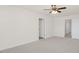Spacious bedroom with neutral carpet, ceiling fan, and multiple doorways for easy access at 94 Paper Birch Way, Fuquay Varina, NC 27526