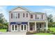 New two-story home with stone accents, gray siding, burgundy shutters, and a covered porch at 94 Paper Birch Way, Fuquay Varina, NC 27526