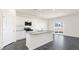Modern kitchen with a large island, granite countertops, and stainless steel appliances at 94 Paper Birch Way, Fuquay Varina, NC 27526
