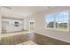 Bright and airy kitchen featuring modern white cabinetry, an island, stainless steel appliances, and wood-look floors at 99 Paper Birch Way, Fuquay Varina, NC 27526