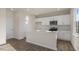 A bright kitchen with white cabinetry, stainless steel appliances, and a center island at 99 Paper Birch Way, Fuquay Varina, NC 27526