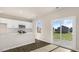 Stylish kitchen with white cabinets, stainless steel appliances, a peninsula island, and sliding glass door at 99 Paper Birch Way, Fuquay Varina, NC 27526