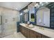 Beautiful bathroom featuring dual sinks, a glass-enclosed shower with a rain shower head, and stylish blue tiling at 0 High Rock Rd, Efland, NC 27243