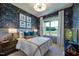 Cozy bedroom with stylish wallpaper, comfortable bed, and natural light, creating a relaxing and inviting atmosphere at 0 High Rock Rd, Efland, NC 27243