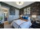 A cozy bedroom with patterned wallpaper, wainscoting, and stylish decor at 0 High Rock Rd, Efland, NC 27243