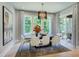 Elegant dining room with a modern chandelier, large windows providing natural light, and stylish decor at 0 High Rock Rd, Efland, NC 27243