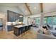 Modern kitchen with gray cabinets, a large island with seating, and an open layout to the dining and living areas at 0 High Rock Rd, Efland, NC 27243