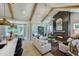 Bright open living room with vaulted ceilings, wood beams, a fireplace, and access to the porch at 0 High Rock Rd, Efland, NC 27243