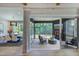 Open-concept with dining area flowing into a screened-in porch featuring a fireplace and views of the surrounding greenery at 0 High Rock Rd, Efland, NC 27243