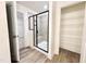 Modern bathroom featuring glass-enclosed shower and organized walk-in closet providing functional spaces at 1020 Channel Drop Lp, Zebulon, NC 27597