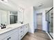 Modern primary bathroom with dual vanity, walk-in shower, and spacious walk-in closet enhancing convenience at 1020 Channel Drop Lp, Zebulon, NC 27597