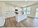 Modern kitchen with a large island, quartz countertops, stainless appliances, and light-filled windows at 1020 Channel Drop Lp, Zebulon, NC 27597
