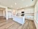 Spacious kitchen with white cabinets, quartz counters, stainless appliances, and large center island at 1020 Channel Drop Lp, Zebulon, NC 27597
