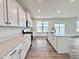 Modern kitchen with stainless appliances, quartz countertops, white cabinets, and a center island at 1020 Channel Drop Lp, Zebulon, NC 27597