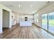 Bright, open kitchen features white cabinets, center island with quartz counters, and stainless appliances at 1020 Channel Drop Lp, Zebulon, NC 27597