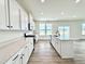 Bright kitchen with stainless appliances, quartz countertops, white cabinets, and a center island at 1020 Channel Drop Lp, Zebulon, NC 27597