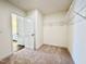 Carpeted walk-in closet features wire shelving and ample room, enhancing bedroom storage convenience at 1020 Channel Drop Lp, Zebulon, NC 27597