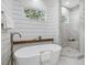 A luxurious bathroom featuring a standalone tub, an open shower, and modern design at 104 Pointe Park Cir, Holly Springs, NC 27540