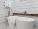 A luxurious bathroom featuring a standalone tub, an open shower, and modern design at 104 Pointe Park Cir, Holly Springs, NC 27540