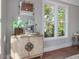Bedroom features a stylish dresser, decorative mirror and a large window with views of the outdoors at 104 Pointe Park Cir, Holly Springs, NC 27540