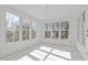 Bedroom filled with natural light, featuring many windows and a pleasant view of nature at 104 Pointe Park Cir, Holly Springs, NC 27540