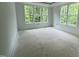 Bright bedroom featuring large windows, neutral walls, and an abundance of natural light at 104 Pointe Park Cir, Holly Springs, NC 27540