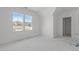 Spacious bedroom features white walls, large windows, and natural light at 104 Pointe Park Cir, Holly Springs, NC 27540