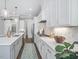 Bright kitchen featuring a large island with seating, pendant lighting, and modern appliances at 104 Pointe Park Cir, Holly Springs, NC 27540