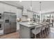 Modern kitchen with white cabinets, stainless steel appliances, and a center island with bar seating at 104 Pointe Park Cir, Holly Springs, NC 27540