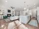 Open concept living space with a fireplace, island kitchen, and hardwood flooring at 104 Pointe Park Cir, Holly Springs, NC 27540