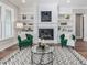 Comfortable living room features a fireplace, built-in shelving, and a modern rug at 104 Pointe Park Cir, Holly Springs, NC 27540