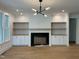 Bright living room featuring a fireplace, built-in cabinets, open shelves, and modern lighting at 104 Pointe Park Cir, Holly Springs, NC 27540