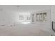 Open-concept living room boasting plentiful windows, lots of natural light, and access to the back porch at 104 Pointe Park Cir, Holly Springs, NC 27540