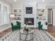 Inviting living room features fireplace flanked by built-in shelving and large windows at 104 Pointe Park Cir, Holly Springs, NC 27540