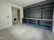 Living room featuring a custom built-in shelving unit, offering stylish storage and display space at 104 Pointe Park Cir, Holly Springs, NC 27540