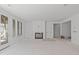 Bright living room featuring a fireplace, large windows, and access to an outdoor porch at 104 Pointe Park Cir, Holly Springs, NC 27540