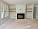 Comfortable living room showcasing a fireplace and built-in shelves waiting to be finished at 104 Pointe Park Cir, Holly Springs, NC 27540