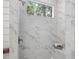 Luxurious tiled shower featuring a built-in seat and window offering natural light and outdoor views at 104 Pointe Park Cir, Holly Springs, NC 27540
