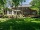 Expansive backyard with well-maintained lawn, brick exterior, and sunroom at 107 Marseille Pl, Cary, NC 27511