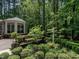 Backyard featuring a deck with an attached sunroom and landscaped garden for outdoor enjoyment at 107 Marseille Pl, Cary, NC 27511