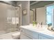 This bathroom features a shower-over-tub with glass screen, neutral tile, and a white vanity sink at 107 Marseille Pl, Cary, NC 27511