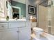 Well-maintained bathroom features a white vanity, a framed mirror, a toilet, and a glass-enclosed shower at 107 Marseille Pl, Cary, NC 27511