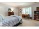 Cozy bedroom featuring natural light, an area for a desk, and wood furniture at 107 Marseille Pl, Cary, NC 27511