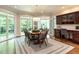 Cozy dining area featuring hardwood floors, lots of windows, and a built-in desk with a dark wood finish at 107 Marseille Pl, Cary, NC 27511