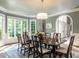 Formal dining room with large windows, chandelier, and ample seating at 107 Marseille Pl, Cary, NC 27511