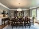 Dining room with a dark wood table, seating for eight, chandelier and custom cabinets at 107 Marseille Pl, Cary, NC 27511